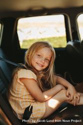 Beautiful girl travelling in backseat of the car 49qeE4