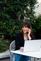 Transgender woman taking a phone call outside