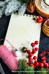 Blank notebook on table surrounded by Christmas decor and baking ingredients 41VOgb