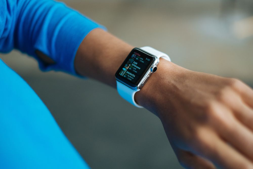 Cropped image of a person looking at their Apple watch