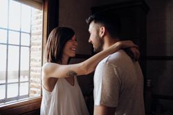 Happy couple embracing in kitchen