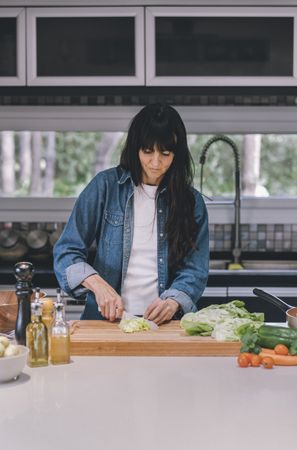 woman housewife preparing fresh salad Vertical shot