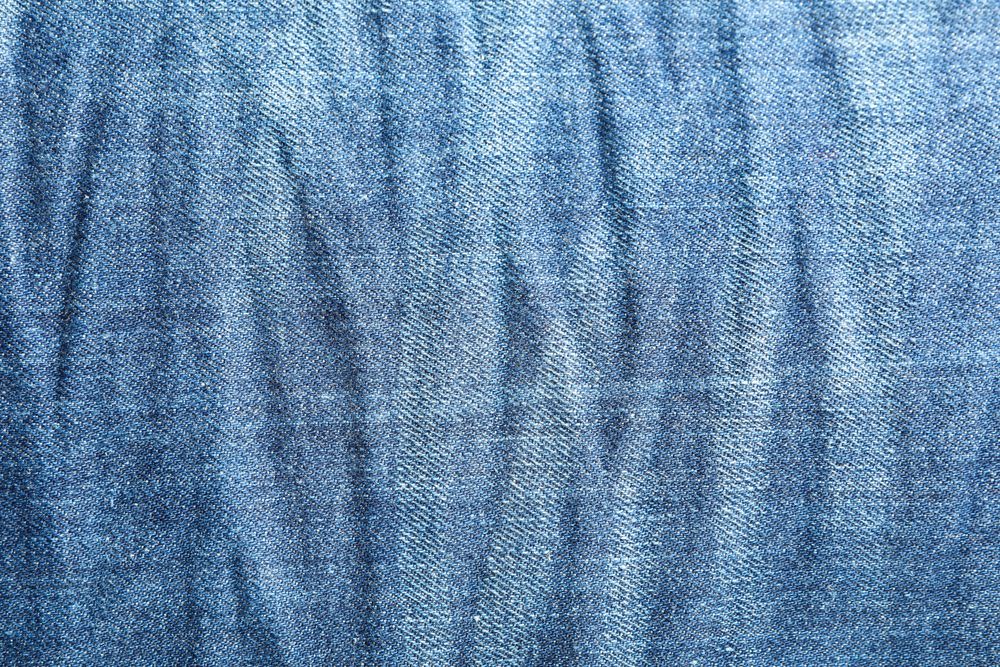 Texture of blue jeans as background, space for text