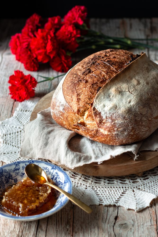 Sourdough bread near flowers and honey