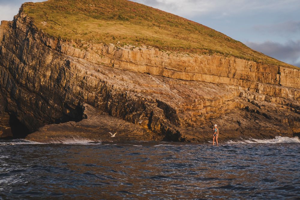 Woman on paddleboard floating in sea