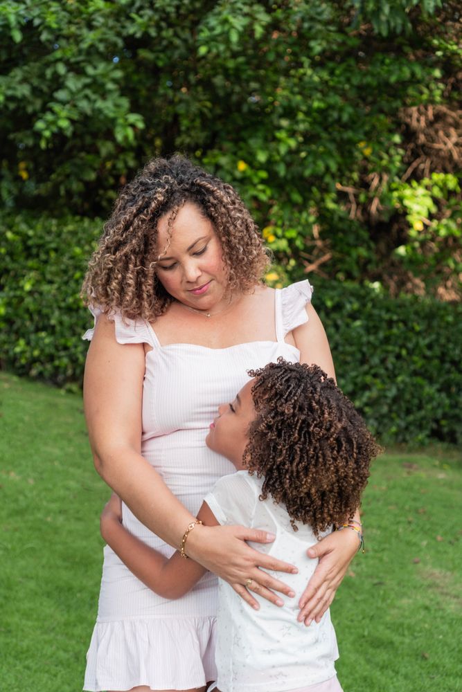 Latina mother and daughter spend time together outdoors.