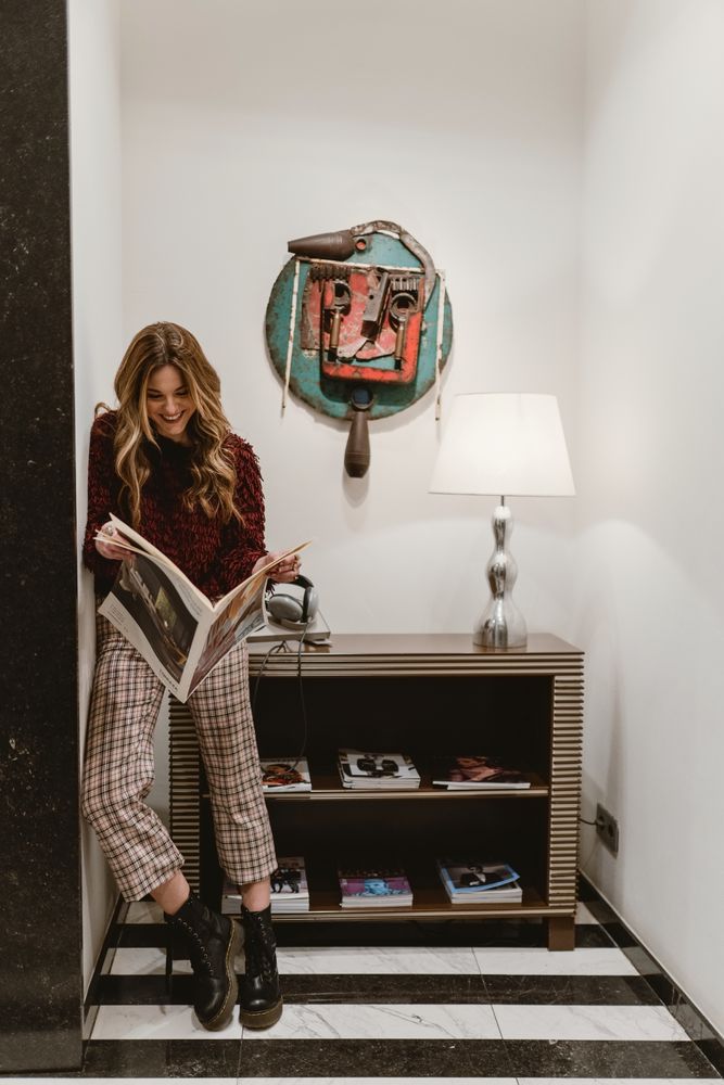 Stylish woman reading magazine