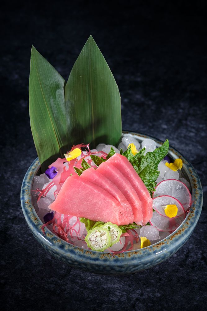 Ceramic plate with raw fish and vegetables