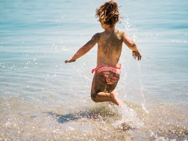 Cheerful girl having fun in warm sea