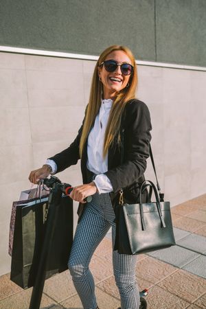 Woman with shopping bags on electric scooter