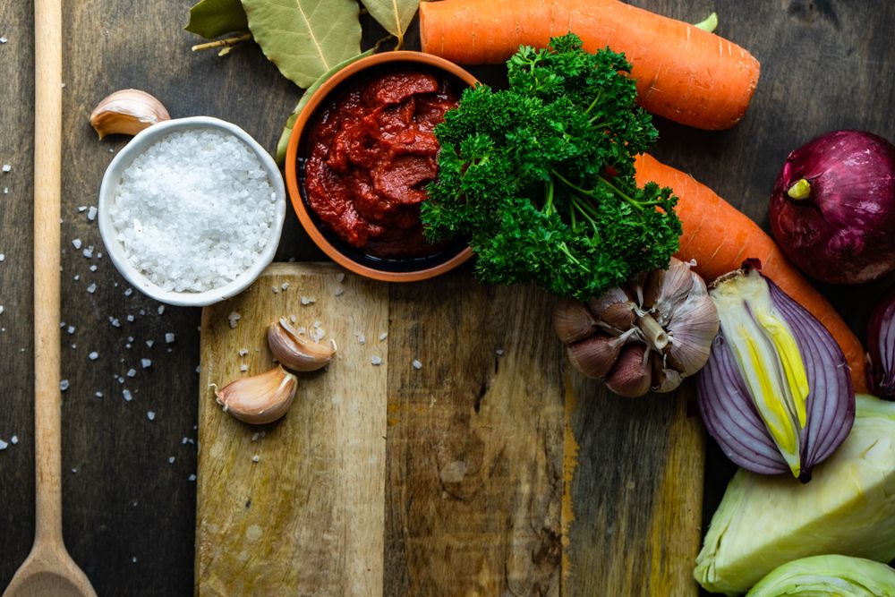 Tomato paste with carrot, bay leaf & onion ready for food prep