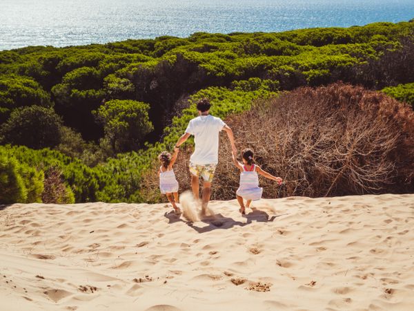 Anonymous family walking in the beach