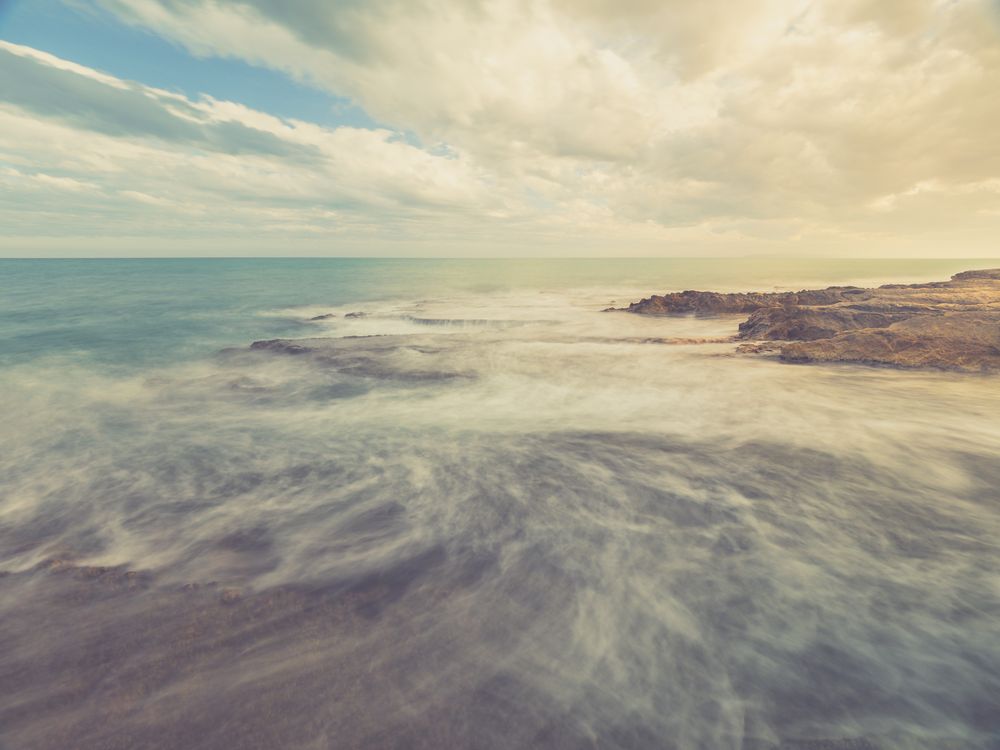 Rocky seashore under blue sky