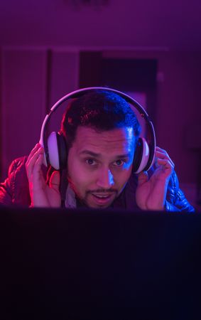 Man listening cheerfully to music with headphones.