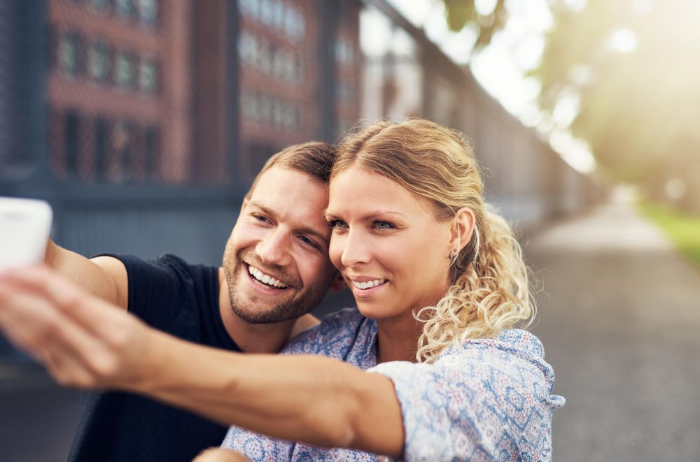 Couple smiling while taking selfie