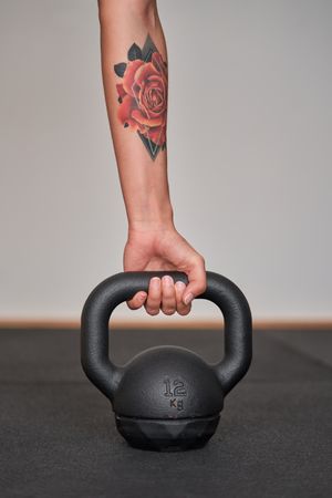 Anonymous woman holding metal kettlebell