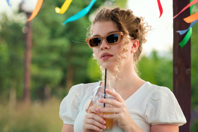 Woman with drink outdoors