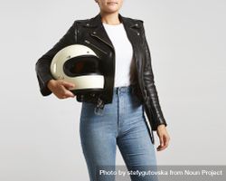 Woman in dark leather jacket with light t-shirt holding motorcycle helmet 4mm9W4