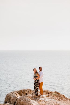 Couple embracing on rock