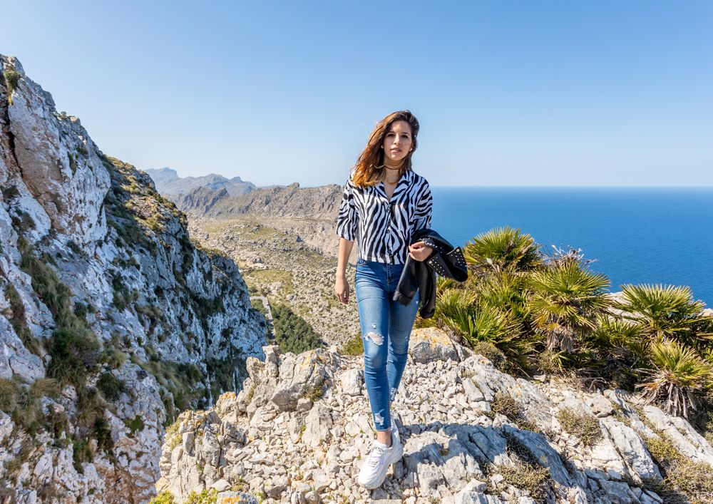 Young woman standing on cliff