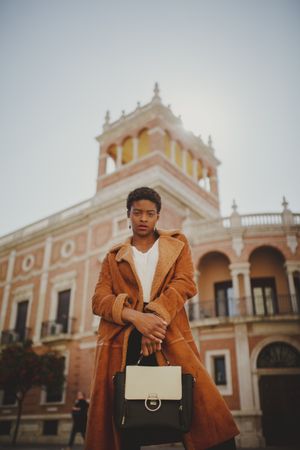 Stylish Black woman with handbag on street