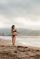 Slim woman running on beach