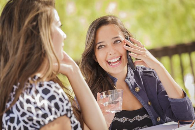 Happy Women Talking on Their Mobile Cell Phones