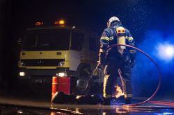 Muscular firefighter on mission