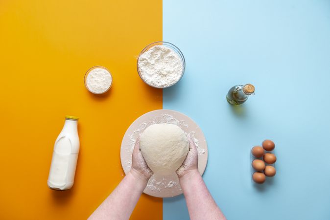 Baking flat lay with woman holding dough
