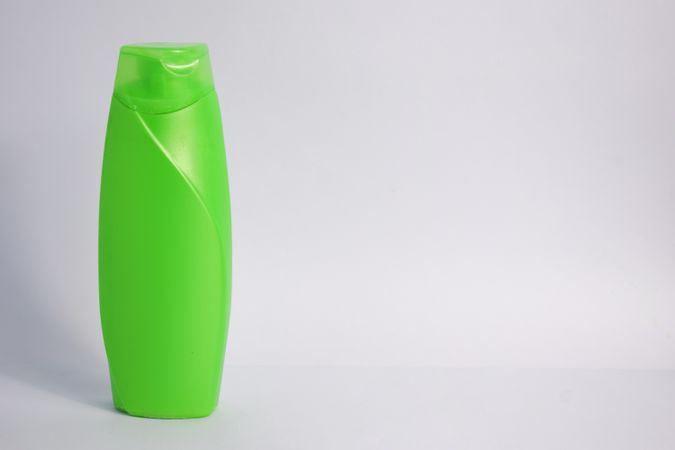 Green body wash bottle with no labels and copy space