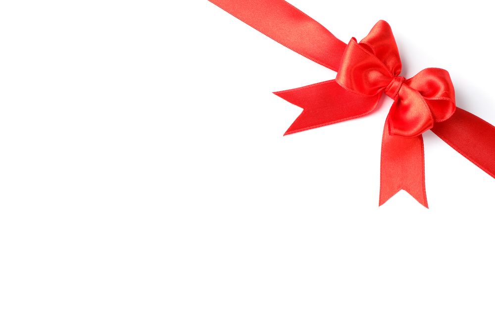 Red ribbon with bow isolated on plain background. Gift concept