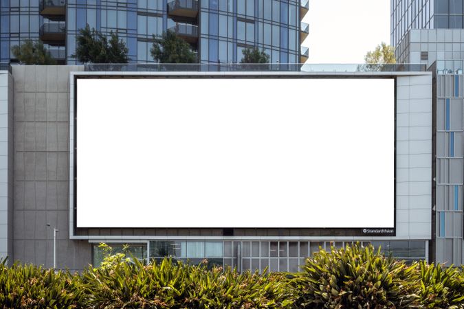 Large LED billboard mock up on modern office buildings in city