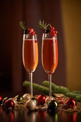 Glasses with champagne amidst Christmas baubles
