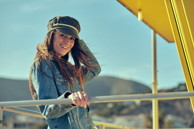 female standing on balcony on nature