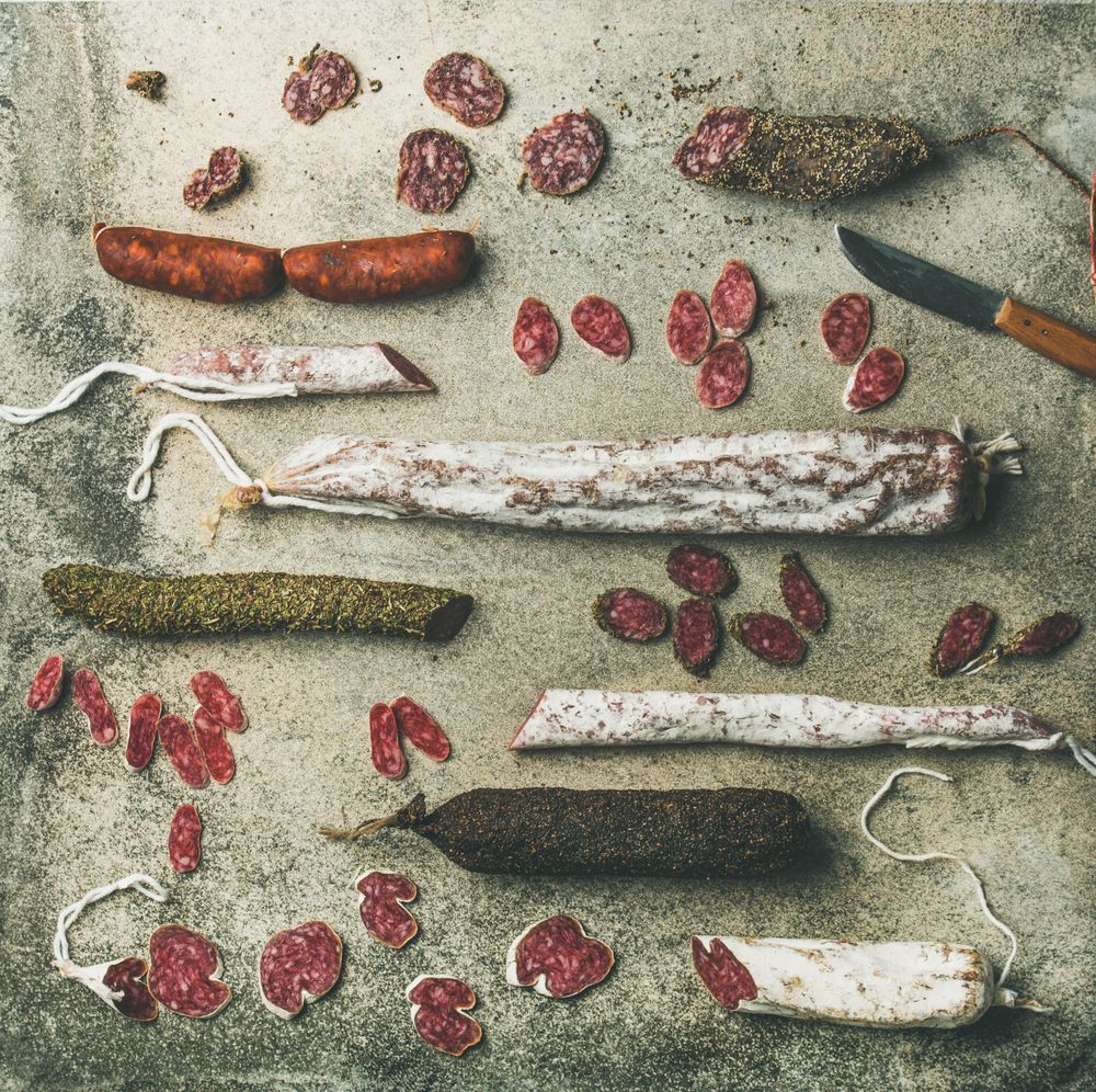 Top view of sliced Italian cured sausages in butcher’s shop