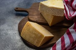 Wheel of Italian parmesan cut in chunks