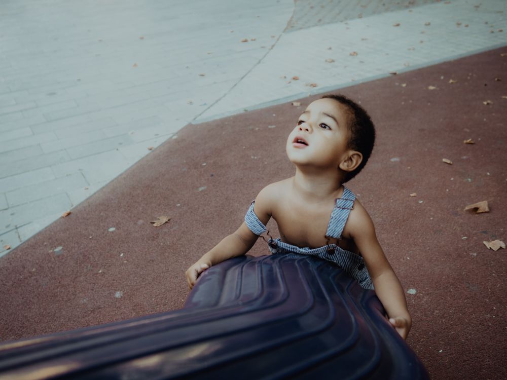 funny boy playing in a playground outdoors