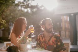 Loving couple clinking glasses on cafe terrace