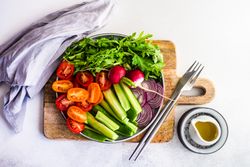 Top view of healthy chopped vegetables on wooden board