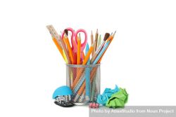 Pencils, scissors & assortment of stationary in container in plain space 5pJVgb