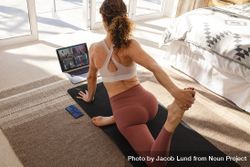 Woman teaching yoga online to group of people from home 4ZN3O4