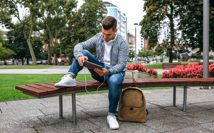 Young man using tablet outdoors