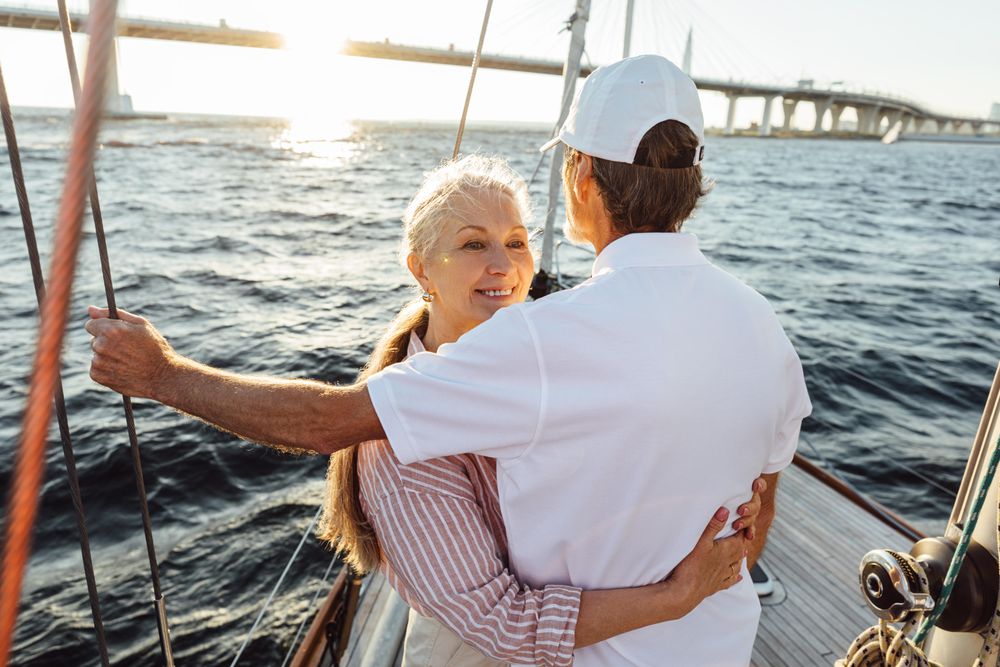 Romantic couple embracing on a boat at sunset