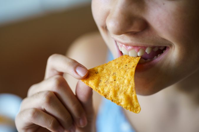Teenager eating chips