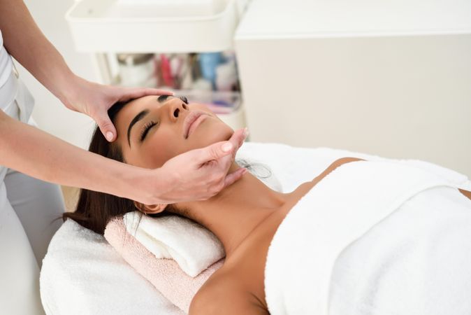 Woman receiving a massage from a professional aesthetician
