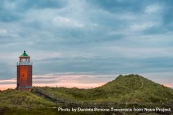 Sunset scenery with an old lighthouse on the hills of Sylt island, in North Sea, Germany 0yEzR0