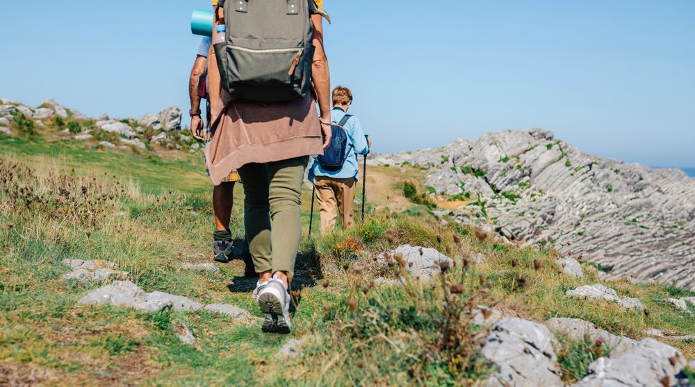 Group of people with backpacks and equipment hiking outside