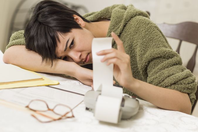 Young Female Agonizing Over Financial Calculations