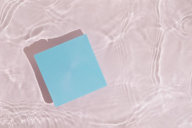Blue paper card floating in water