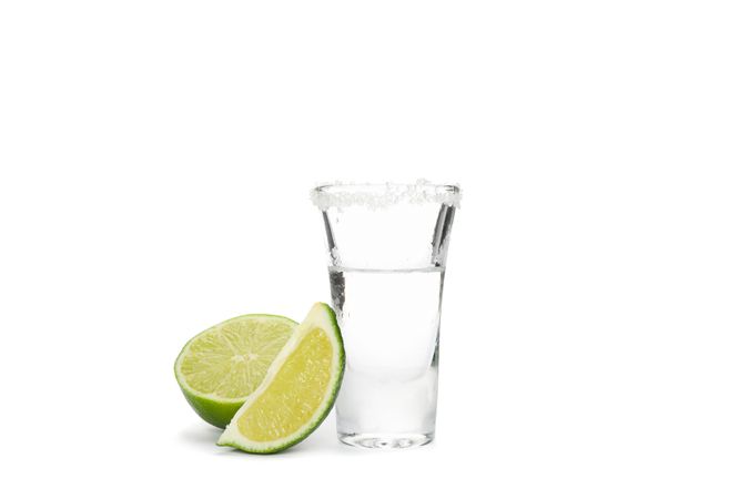 Tequila shot with lime and salt isolated on blank background